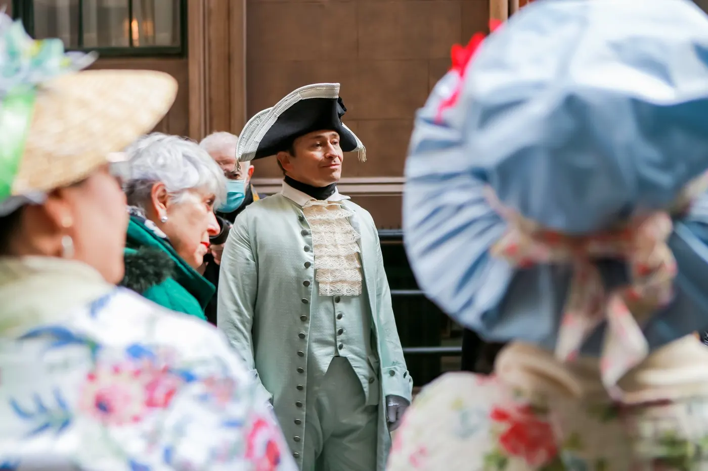 Hamilton greeting walking-tour guests on a Lower Manhattan street