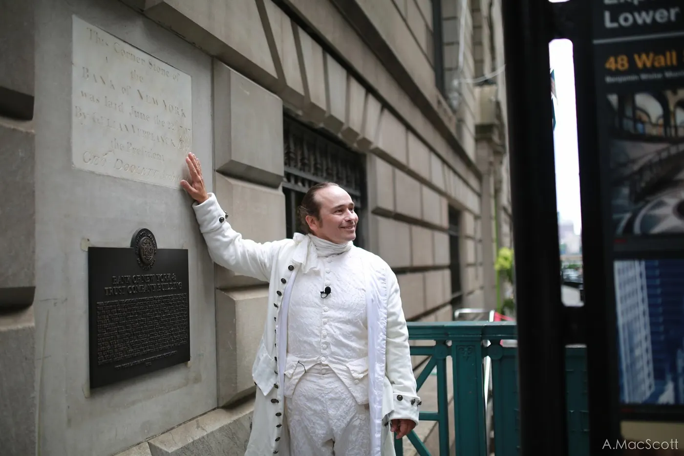 Hamilton pointing out a plaque at Federal Hall