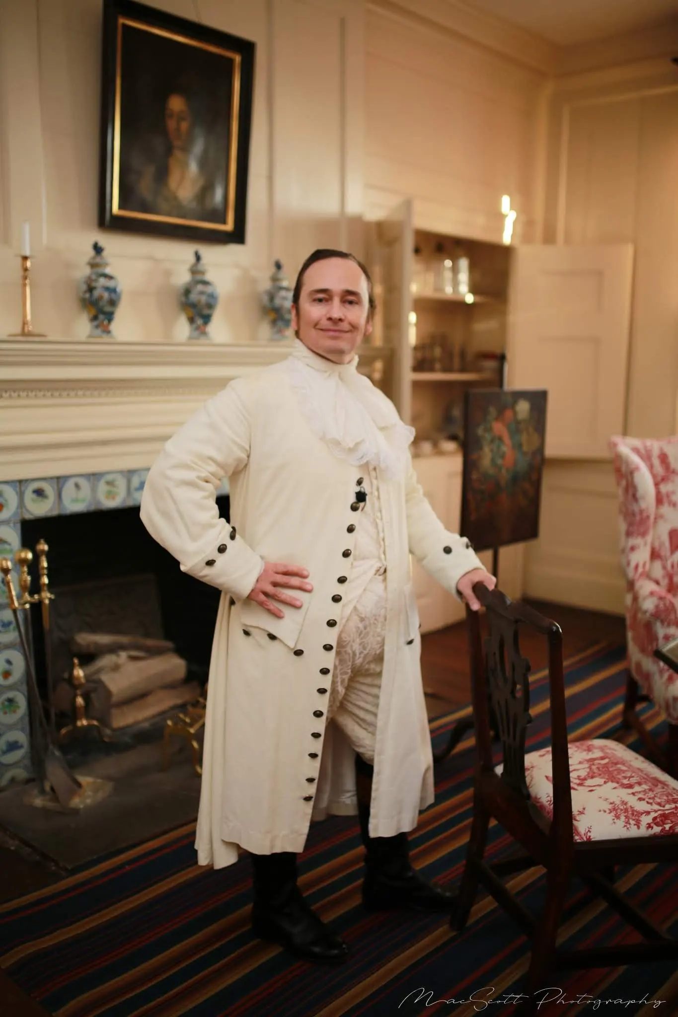 White colonial coat with brass buttons in a blue room